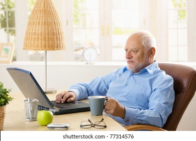 elderly-man-using-laptop-computer-260nw-77314576